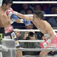 Daigo Higa lands a punch on Mexico\'s Moises Fuentes during their WBC flyweight world title bout in Naha on Sunday. | KYODO