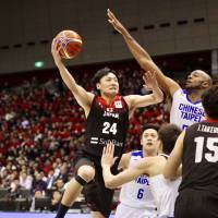 Japan guard Daiki Tanaka goes up for a shot against Taiwan in their FIBA World Cup qualifier game at Yokohama International Swimming Pool on Thursday night. Taiwan edged Japan 70-69. | KAZ NAGATSUKA
