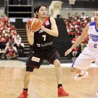 Japan point guard Ryusei Shinoyama looks to make a pass against Taiwan on Thursday. | KAZ NAGATSUKA