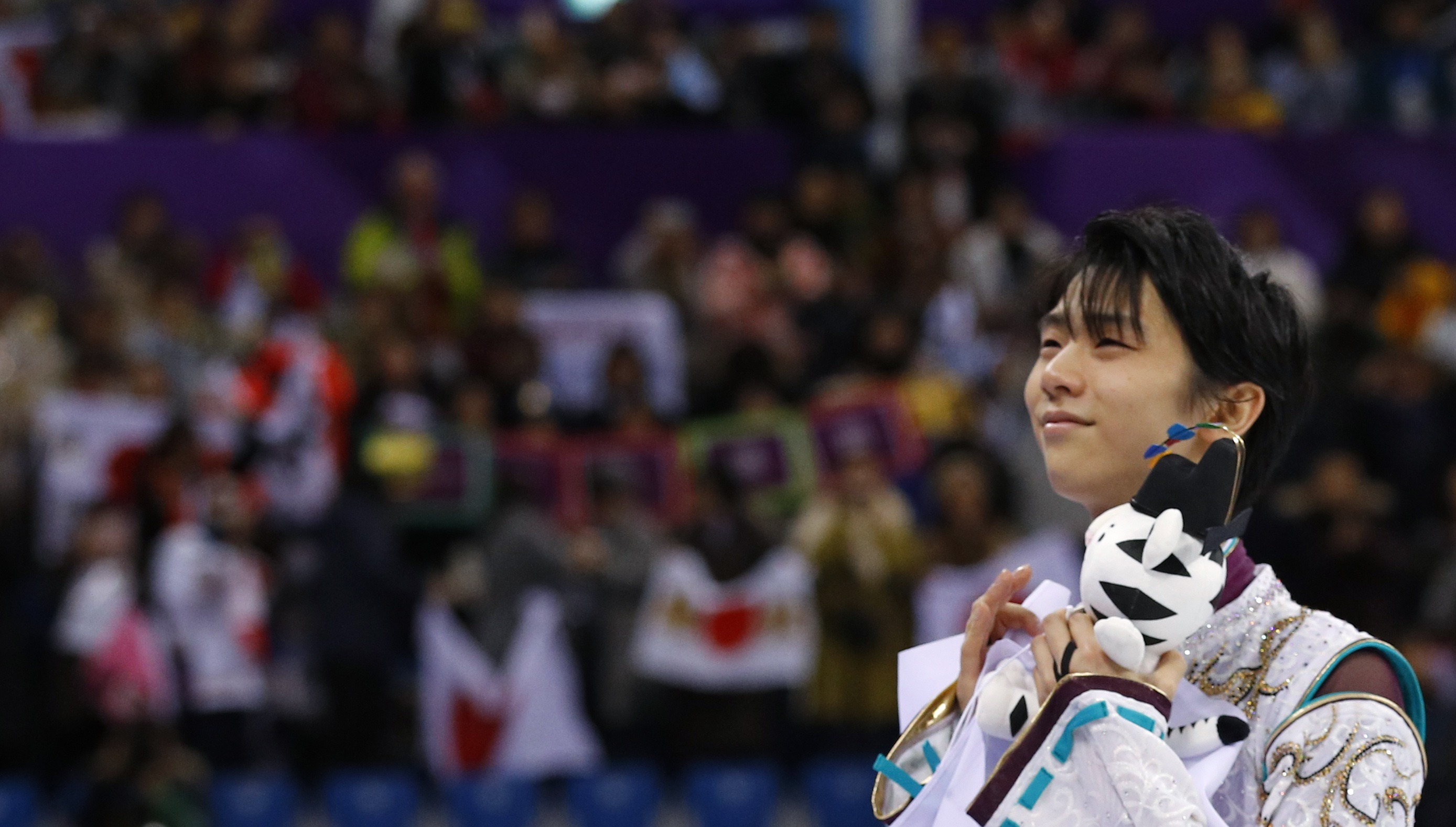 Gold medallist Yuzuru Hanyu of Japan celebrates savors the moment following his victory in the men's single free skating competition.  | REUTERS