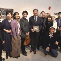 Nonprofit organization Ban Rom Sai Japan representative Miho Natori (third from left) poses for a photo with Thai Ambassador Bansarn Bunnag (center) and his wife, Yupadee (fourth from left), at a reception at Ginza Itoya on Feb. 3. Crouching at the front of the photo are shadow puppet artist Koheisai Kawamura (front left) and curator Takenori Miyamoto (front right). | YOSHIAKI MIURA