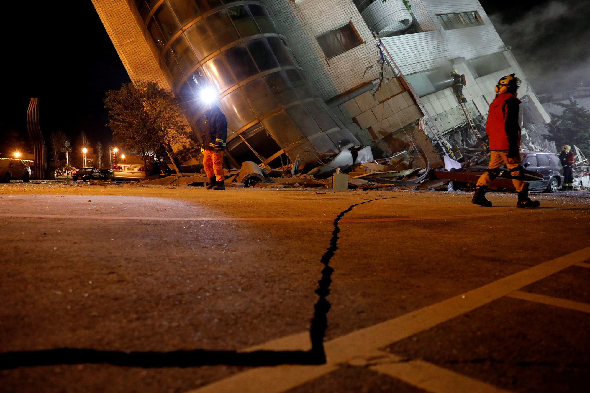 Rescue personnel search in Hualien, Taiwan, early Wednesday after a magnitude 6.4 earthquake brought deaths, with well over a hundred people still missing, and hundreds of injuries. | REUTERS