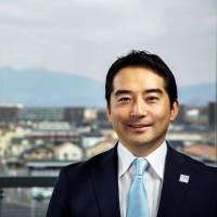 Tsukuba Mayor Tatsuo Igarashi with the iconic Mount Tsukuba in the distance. | CITY OF TSUKUBA