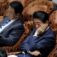 Prime Minister Shinzo Abe and Finance Minister Taro Aso, who also serves as deputy prime minister, attend a Lower House Budget Committee session at the Diet on Tuesday. | REUTERS