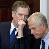 Robert Lighthizer (left), U.S. trade representative, left, speaks with Peter Navarro, director of the National Trade Council, at a ceremony before U.S. President Donald Trump signs proclamations on adjusting imports of steel and aluminum into the United States in the Roosevelt Room of the White House in Washington on March 8. | BLOOMBERG