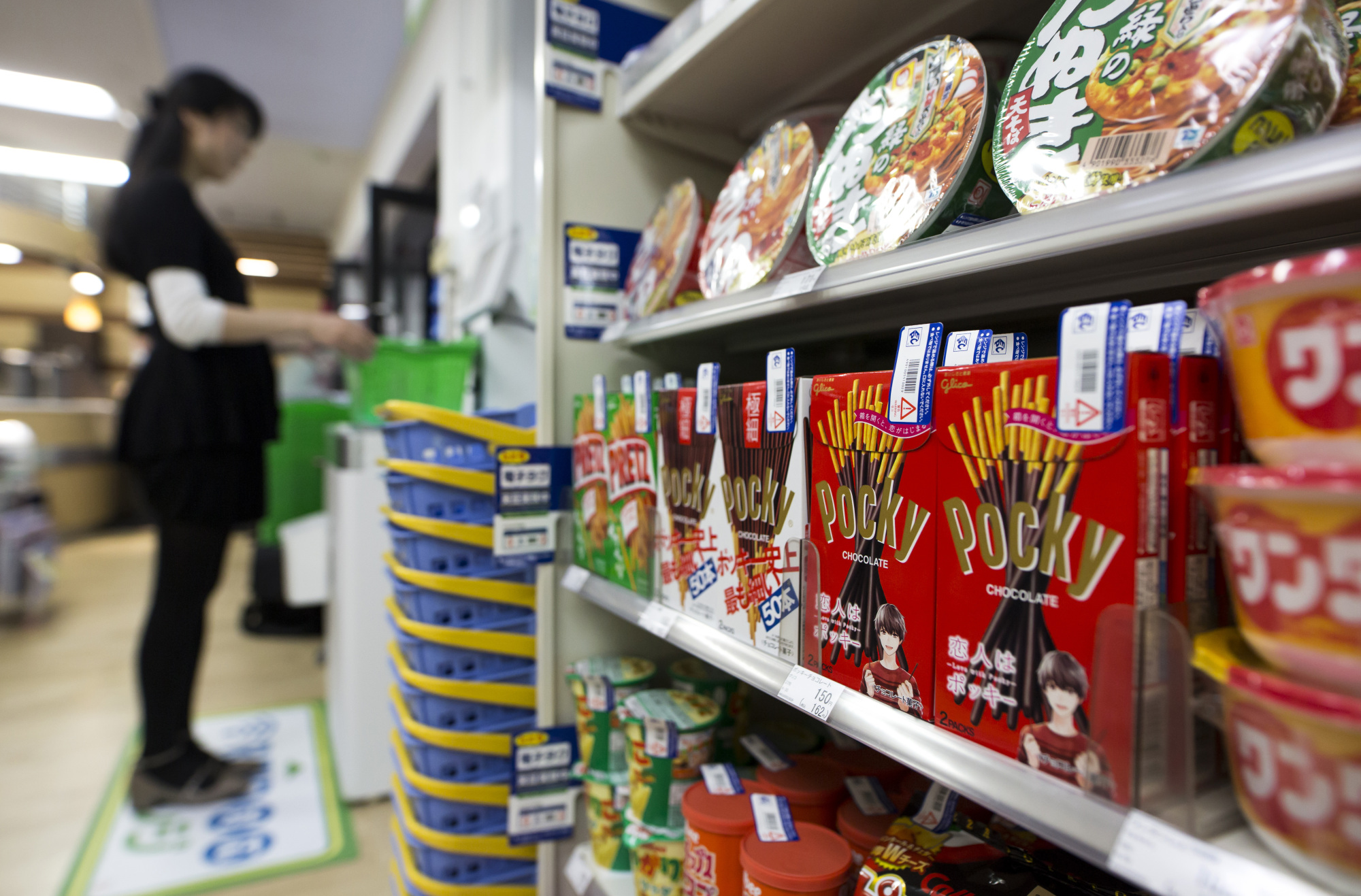 Radio-frequency identification (RFID) tags are seen attached to boxes of Ezaki Glico Co. Pocky snacks at a FamilyMart convenience store in Tokyo on Feb. 23. | BLOOMBERG