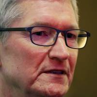 Apple CEO Tim Cook attends the annual session of China Development Forum 2018 at the Diaoyutai State Guesthouse in Beijing on Saturday. | REUTERS