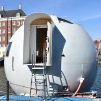Huis Ten Bosch Co. unveils a floating capsule hotel on Tuesday in Sasebo, Nagasaki Prefecture. | KYODO