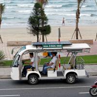 People drive past a beach in Da Nang, Vietnam, on Wednesday. | REUTERS