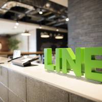 Line Corp. signage is displayed at the offices of Line Fukuoka Corp., a subsidiary in Fukuoka, in March 2017. Line and Nomura Holdings Inc. are considering jointly providing securities services. | BLOOMBERG
