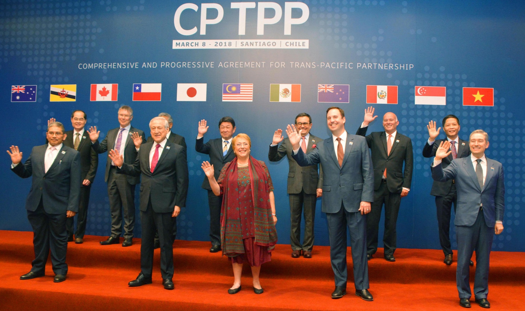 Ministers of the Trans-Pacific Partnership member countries pose for a photo in Santiago Thursday prior to the signing of an agreement without the United States. | KYODO