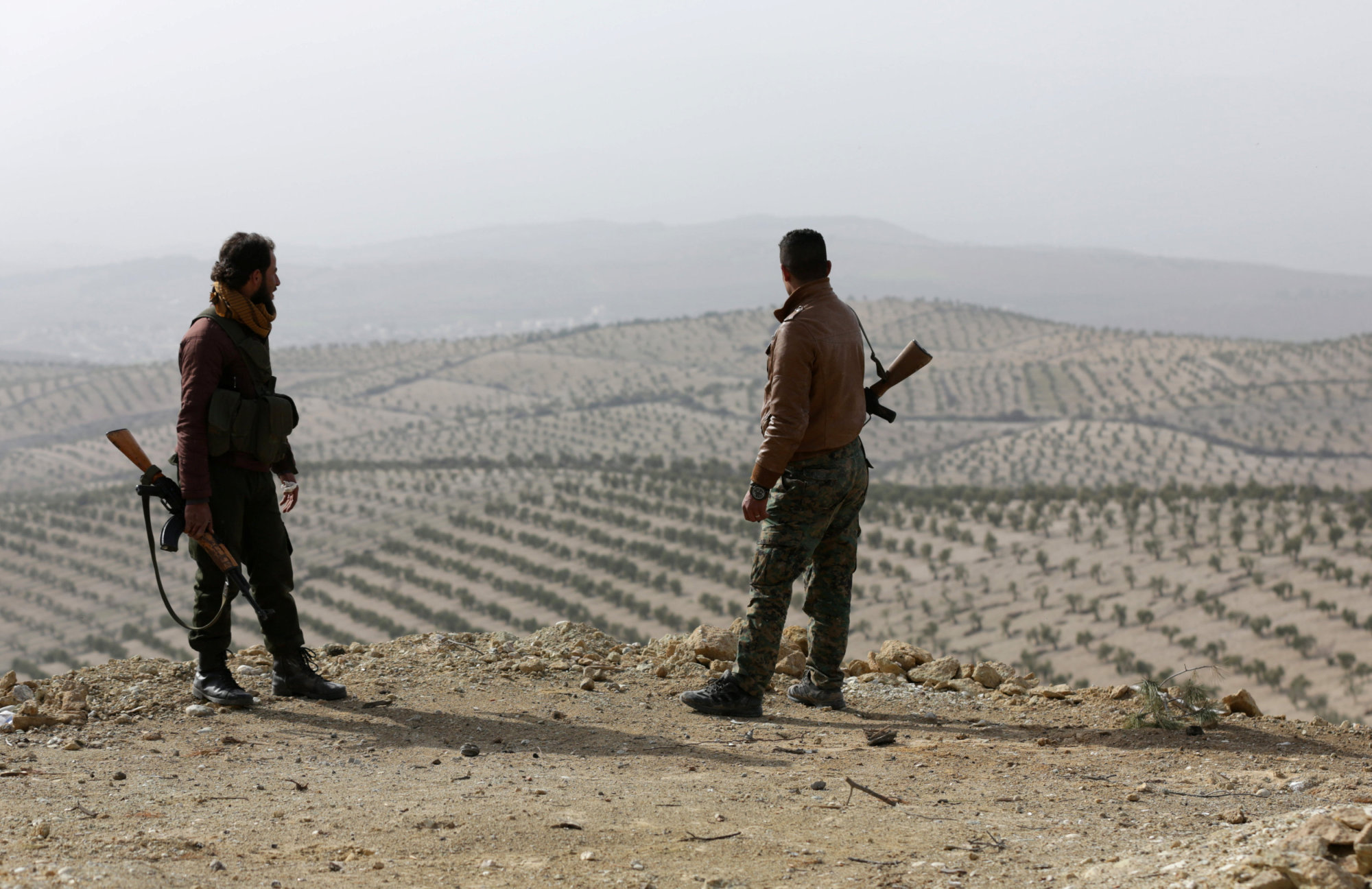 Turkish-backed Free Syrian Army fighters stand atop of mount Bafliyun, in the Afrin region of Syria Monday. | REUTERS