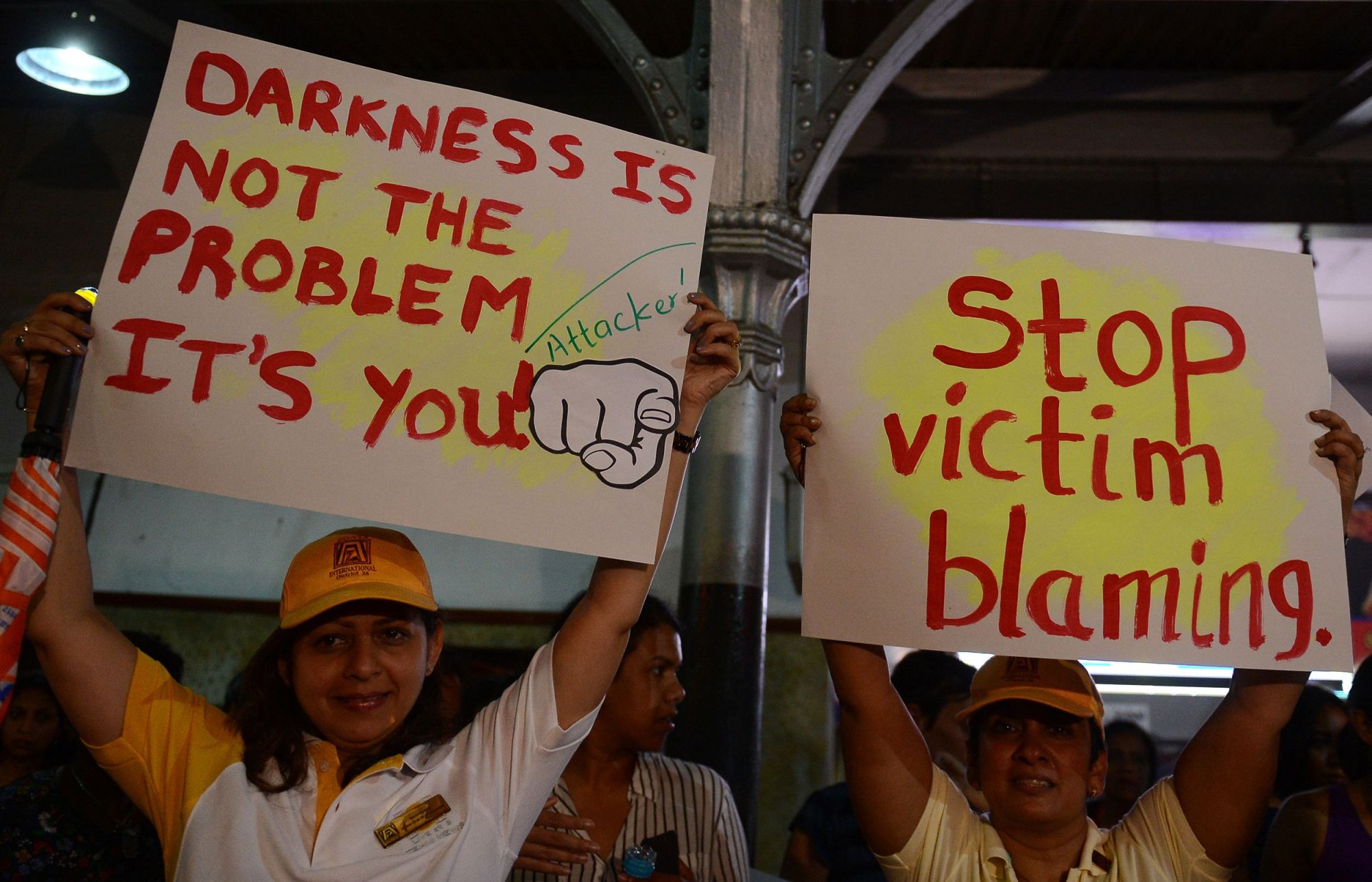 Women carry banners during a 'Safe Sights, Safe Streets and Safe Homes for Women' evening demonstration on Monday in Colombo. | AFP-JIJI
