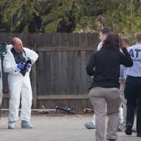 ATF crime scene investigators and law inforcement personnel gather evidence at the home of suspected bomber Mark Anthony Conditt on Thursday in Pflugerville, Texas. The man suspected of carrying out a series of bombings in Austin blew himself up on Wednesday, leaving behind a recorded video \"confession\" that police said portrayed \"challenges in his personal life.\" | AFP-JIJI