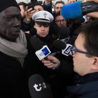 Senegalese spokesman Pape Diaw (left) talks with Florence Mayor Dario Nardella during a demonstration at Vespucci bridge in Florence, Italy, Tuesday. | CLAUDIO GIOVANNINI / ANSA / VIA AP