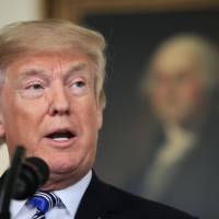 President Donald Trump speaks in the Diplomatic Room of the White House in Washington March 23. | AP