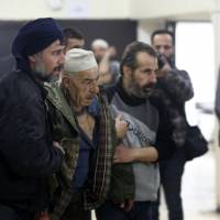 Syrian civilians arrive at a makeshift clinic during Syrian government airstrikes on Zamalka, in the rebel enclave of eastern Ghouta on the outskirts of Damascus, on Tuesday. Syria\'s conflict has killed more than 350,000 people, uprooted more than half the population and left much of the country in ruins since it erupted seven years ago. | AFP-JIJI