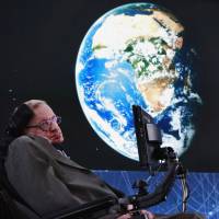 Physicist Stephen Hawking sits on stage during an announcement of the Breakthrough Starshot initiative with investor Yuri Milner in New York in 2016. | REUTERS