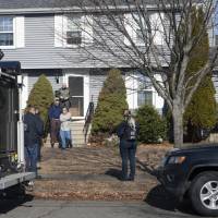 The FBI\'s Joint Terrorism Task Force descend on a home Thursday at 62 Hathaway Ave., in Beverly, Massachusetts, where Daniel Frisiello lives with his parents. Federal authorities said Frisiello, of Beverly, is accused of mailing five envelopes earlier this month with threatening messages and a white substance, which turned out to be nonhazardous. | AMY SWEENEY / THE SALEM NEWS / VIA AP