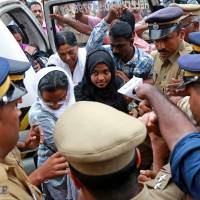 Hadiya, 24, who converted to Islam in 2016 and changed her name from Akhila, arrives at the airport in Kochi, India, November 25, 2017. | REUTERS