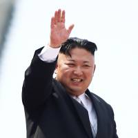 North Korean leader Kim Jong Un waves to people attending a military parade marking the 105th birth anniversary of country\'s founding father, Kim Il Sung, in Pyongyang last year. | REUTERS