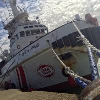 The Spanish NGO\'s Proactiva Open Arms vessel is seen at harbor at the port of Pozzallo, in the southern Italian island of Sicily, Monday. The NGO\'s migrant rescue ship has been put under sequester by prosecutors\' orders Sunday in Pozzallo, where the vessel brought 216 migrants it had rescued last week in the Mediterranean north of Libya. | AP