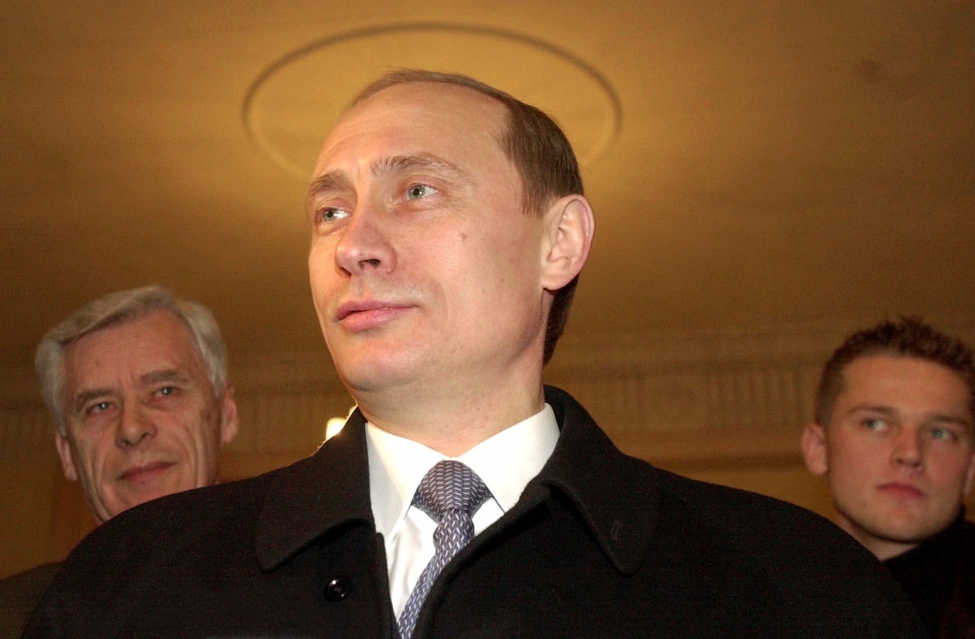 Then acting Russian President and presidential candidate Vladimir Putin talks with representatives of the news media at a polling station in Moscow in 2000. | AP