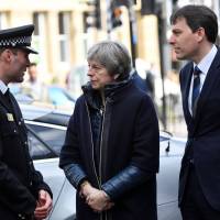 Britain\'s Prime Minister Theresa May talks with Wiltshire Police\'s Chief Constable Kier Pritchard (left) as she arrives in Salisbury, England, on Thursday to visit the areas where former Russian double agent Sergei Skripal and his daughter Yulia went to, and were discovered at, on March 4, following an apparent nerve agent attack. Britain expelled 23 Russian diplomats over the poisoning of the former spy. | AFP-JIJI