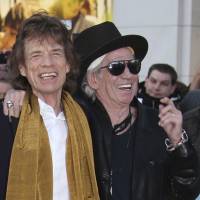 Mick Jagger (left) and Keith Richards pose for photographers upon arrival at the Rolling Stones Exhibitionism preview in London in 2016. Richards says he regrets saying Mick Jagger needed a vasectomy after recently having his eighth child. In a story posted Wednesday morning, | JOEL RYAN / INVISION / VIA AP