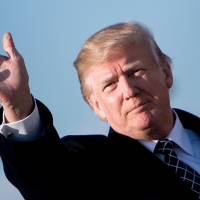 U.S. President Donald Trump waves as he arrives at Andrews Air Force Base, Maryland, Sunday. | AFP-JIJI