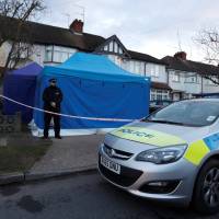 A police officer stands guard outside the home of Nikolai Glushkov in New Malden, Britain, Tuesday. | REUTERS