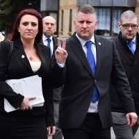 Far-right group Britain First leader Paul Golding and deputy leader Jayda Fransen arrive at Folkestone magristrates court in Kent on Jan. 29. The deputy leader of far-right group Britain First, who hit the headlines after U.S. President Donald Trump retweeted anti-Muslim videos she posted, was jailed on Wednesday for 36 weeks for religiously aggravated harassment. Jayda Fransen, 31, filmed and posted online videos of people whom she wrongly believed were defendants in a rape trial at Canterbury Crown Court in May 2017, in a case that led to the conviction of three Muslim men and a teenager. | AFP-JIJI