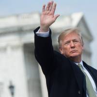 U.S. President Donald Trump waves after the annual Friends of Ireland luncheon at the Capitol in Washington on Thursday. | AFP-JIJI