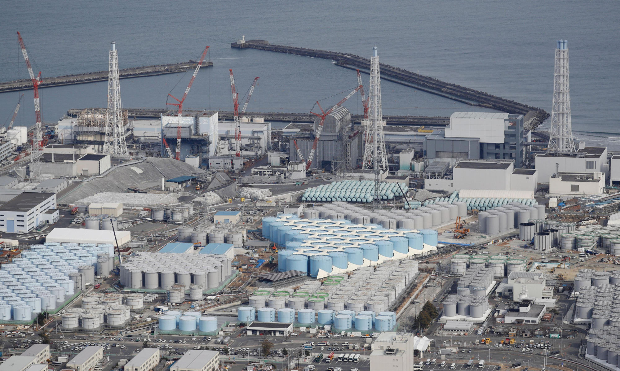 Hundreds of tanks can be seen holding filtered coolant water from the damaged Fukushima No. 1 nuclear power plant. Seven years after the meltdown crisis started, Tokyo Electric Power Company Holdings Inc. is struggling with an ever-increasing volume of radioactive water at the site. | KYODO