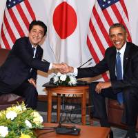 Prime Minister Shinzo Abe and then-U.S. President Barack Obama meet in Hawaii in December 2016. | POOL / VIA KYODO