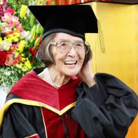 Kiyoko Ozeki, 88, who became the oldest person to earn a doctoral degree in Japan on Saturday, attends a ceremony at Ritsumeikan University in Kyoto. | KYODO
