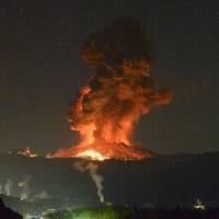 Mount Shinmoe on the border of Kagoshima and Miyazaki prefectures spews lava and smoke during an eruption at 1:55 a.m. Saturday. The event prompted the Meteorological Agency to widen the area at risk from large flying rocks to 4 km from the crater. | KYODO
