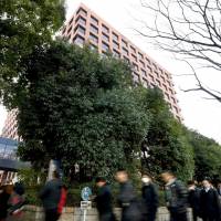 People line up Friday morning in front of the Nagoya High Court to get tickets to a sentencing hearing for a former Nagoya University student convicted of murder. | KYODO