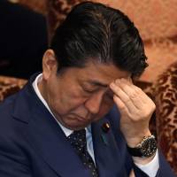 Prime Minister Shinzo Abe attends a recent Upper House budget committee session. Abe and his finance minister Taro Aso have been on the ropes in recent days following revelations that key documents relating to a controversial land sale were doctored. | AFP-JIJI