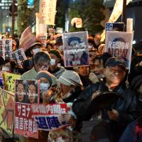 Protesters stage a rally Tuesday against the administration of Prime Minister Shinzo Abe near his official residence in Tokyo. | SATOKO KAWASAKI