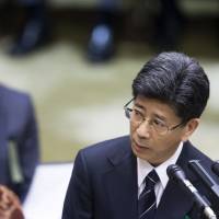 Nobuhisa Sagawa, former head of the financial bureau at the Finance Ministry, testifies during an Upper House budget committee session on Tuesday. | BLOOMBERG