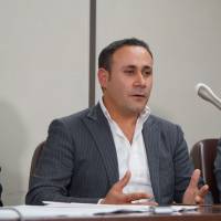 Joude Youssef speaks at a news conference on Tuesday after a ruling by the Tokyo District Court did not qualify him and other plaintiffs for refugee status | CHISATO TANAKA