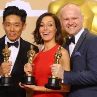 Kazuhiro Tsuji, Lucy Sibbick (center) and David Malinowski show off their Oscar for best makeup and hairstyling for the film \"Darkest Hour\" during the 90th annual Academy Awards in Hollywood, California, on Sunday. | REUTERS