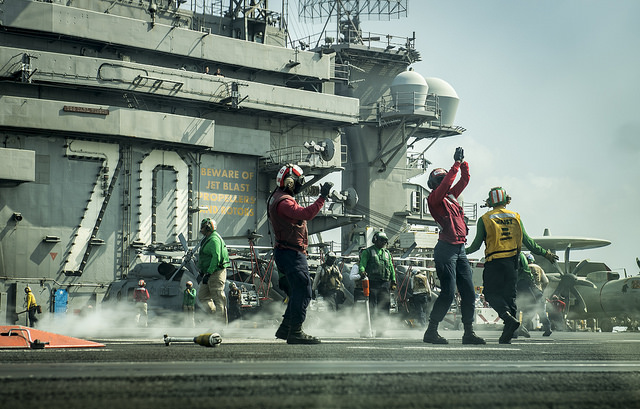 Sailors perform flight operations on the flight deck of the aircraft carrier USS Carl Vinson on Saturday in the South China Sea. | U.S. NAVY