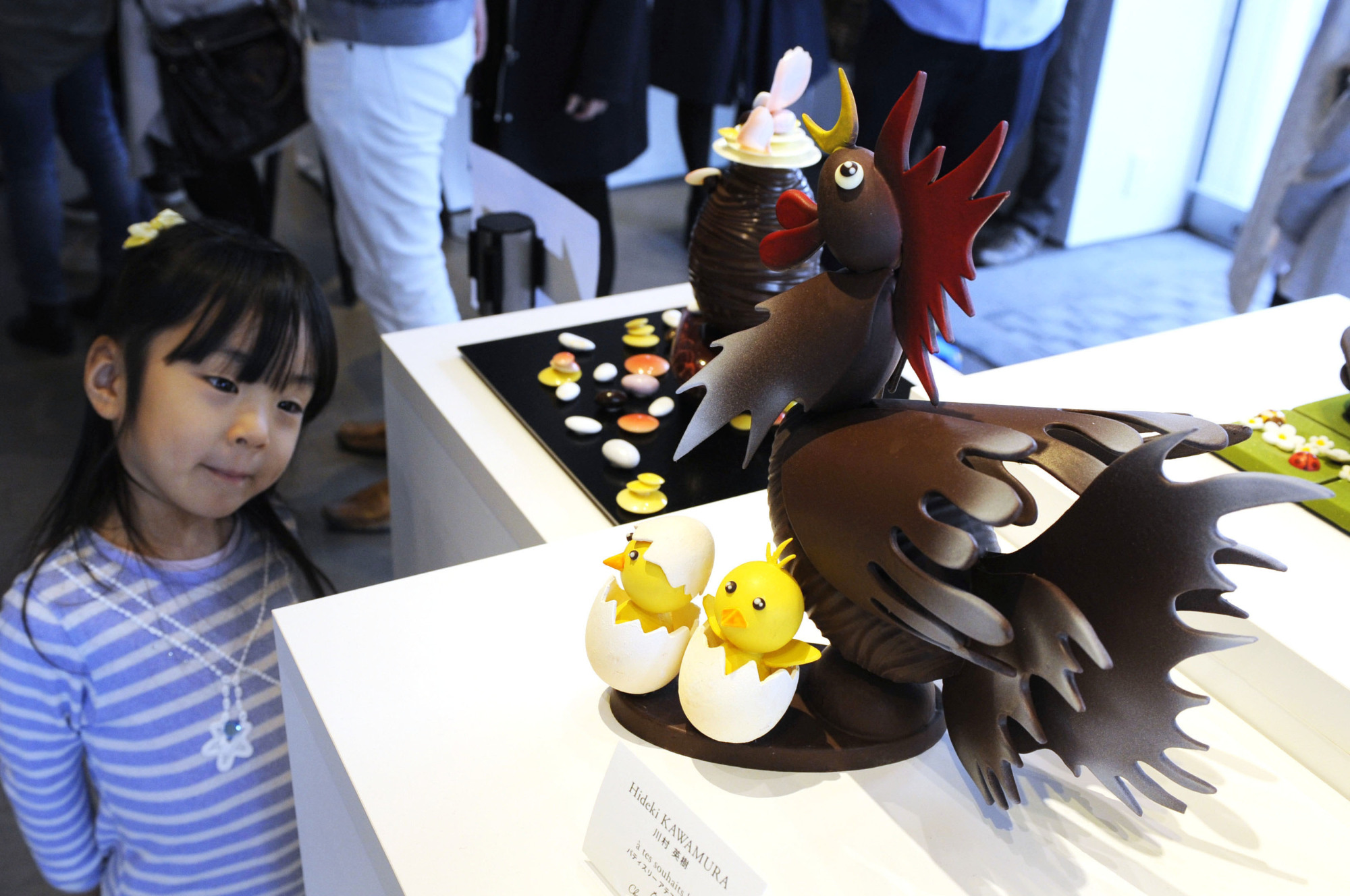 A young child looks at a chocolate cake during an Easter festival in Tokyo's Daikanyama neighborhood in March 2016. | KYODO