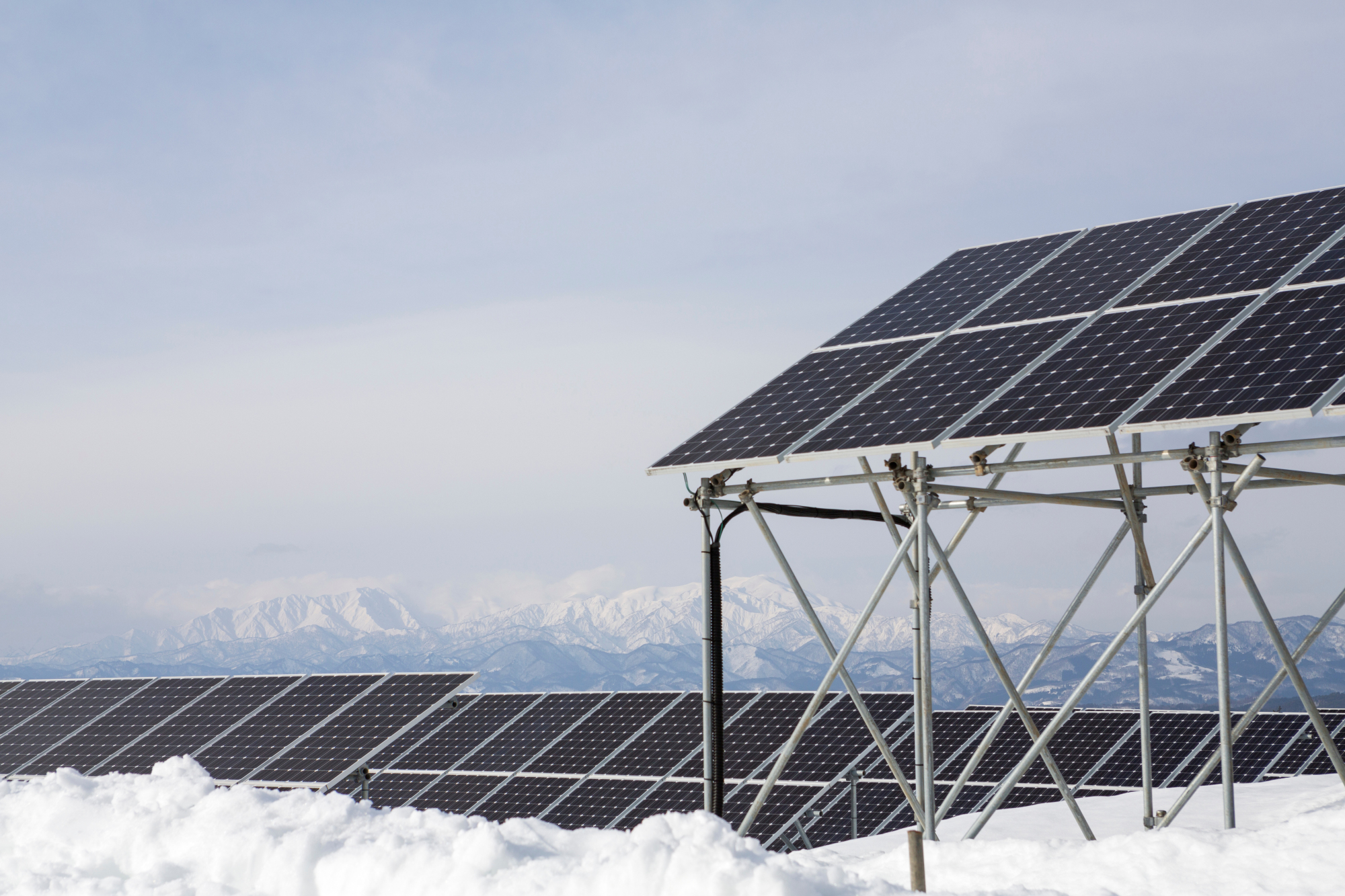 Here comes the sun: Snow sits on the ground around solar panels at Aizu Electric Power Co.'s Oguni power plant in Kitakata, Fukushima Prefecture. The panels are elevated on scaffolding to raise them above the snow during winter. | CHRISTINA SJOGREN