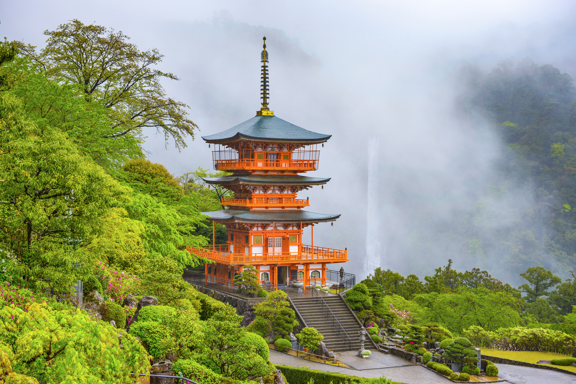 The pagoda of the UNESCO Heritage Seiganto-ji Temple, with the cascading Nachi Falls shrouded in mist in the background, Wakayama Prefecture. | GETTY IMAGES