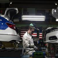 A worker assembles cars at a Honda plant in Ohio. Japanese companies have long invested in America and their U.S. subsidiaries  employed 856,000 workers as of 2015. | BLOOMBERG
