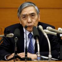 BOJ Gov. Haruhiko Kuroda, shown at a March 9 new conference, will likely feel pressure to keep his cash-injecting policies in place as the economy shows some signs of slowing. | REUTERS