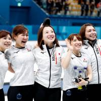Japan\'s (from left) Yurika Yoshida, Chinami Yoshida, Satsuki Fujisawa, Yumi Suzuki and Mari Motohashi celebrate after defeating Great Britain to win the bronze medal in women\'s curling at the Pyeongchang Olympics on Feb. 24. | REUTERS